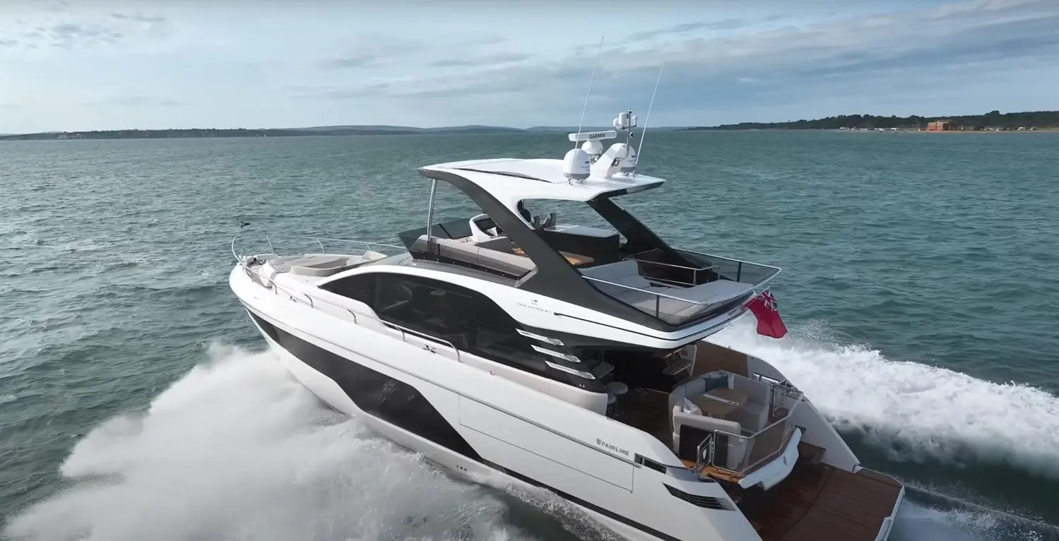 Luxury motor yacht cruising across turquoise waters, featuring sleek design, spacious deck, and Maltese flag visible.